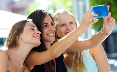 Group of friends taking selfie in the street.  clipart