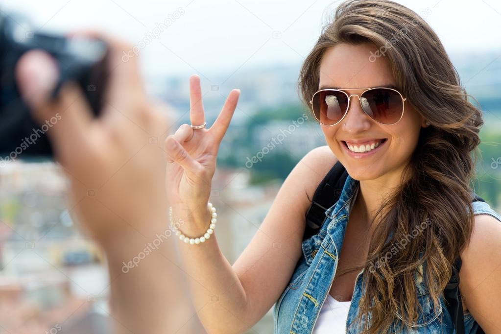 Young men taking photo of his girlfriend.