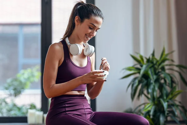 Shot Sporty Young Woman Eating Yogurt While Sitting Fitness Ball — Stock Photo, Image