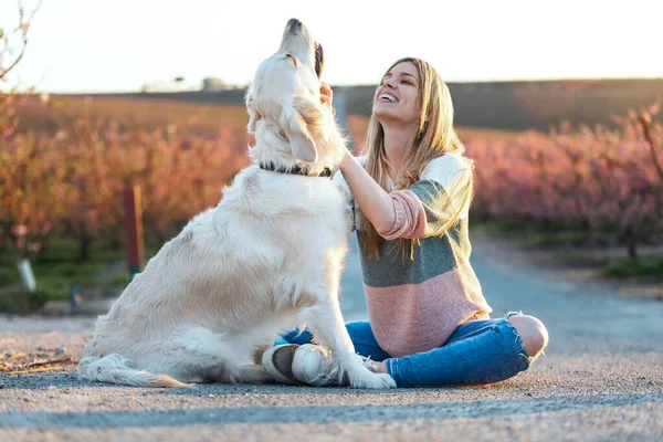 Güzel Bir Kadının Güzel Golden Retriever Köpeğini Okşayıp Pohpohlarken Baharda — Stok fotoğraf