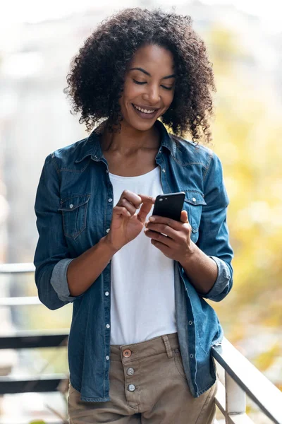 Foto Mujer Alegre Usando Teléfono Inteligente Mientras Envía Mensajes Pie — Foto de Stock