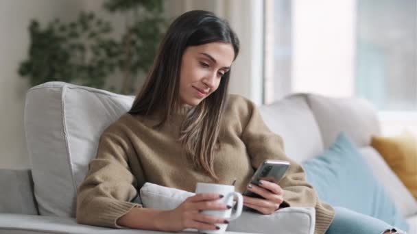 Video Smiling Young Woman Using Her Mobile Phone While Drinking — Stock Video