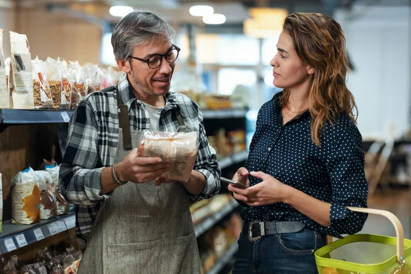 Shot Pretty Young Woman Shopping While Seller Advises Her Purchases — Stock Photo, Image