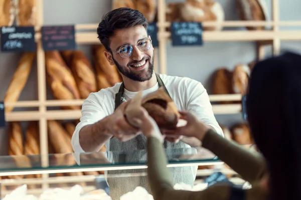 Shot Cheerful Seller Giving Fresh Loaf Bread Smiling Woman Pastry — Photo