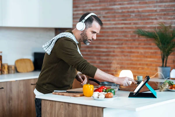 Shot Handsome Mature Man Cooking Recipe Internet Digital Tablet While — Foto Stock