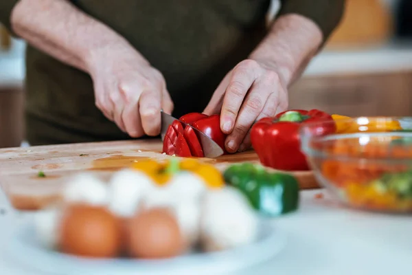 Close Handsome Mature Man Cutting Fresh Vegetables While Listening Music — Stock Photo, Image