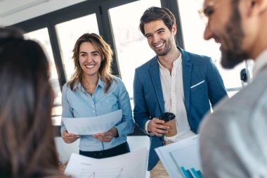 Shot of smart business people working while talking of they new project together in modern startup.