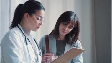 Video of beautiful female doctor talking while explaining medical treatment to patient in the consultation.