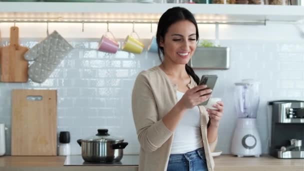 Video Pretty Woman Sending Messages Mobile Phone While Eating Yogurt — Vídeos de Stock