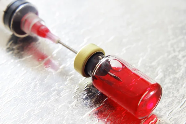 Syringe and blood vial — Stock Photo, Image