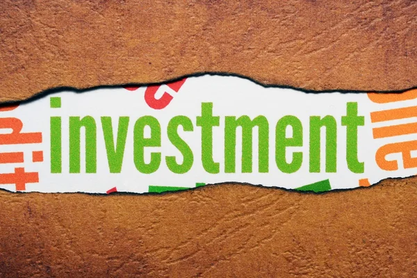 Investment text on torn paper — Stock Photo, Image