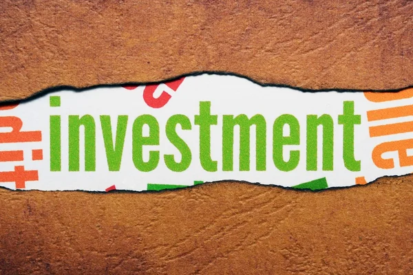 Investment text on torn paper — Stock Photo, Image