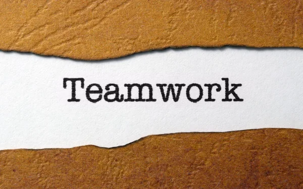 Teamwork on torn paper — Stock Photo, Image