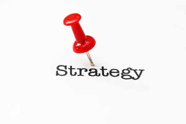 Push pin on strategy text — Stock Photo, Image