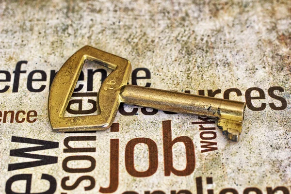 Golden key on job text — Stock Photo, Image