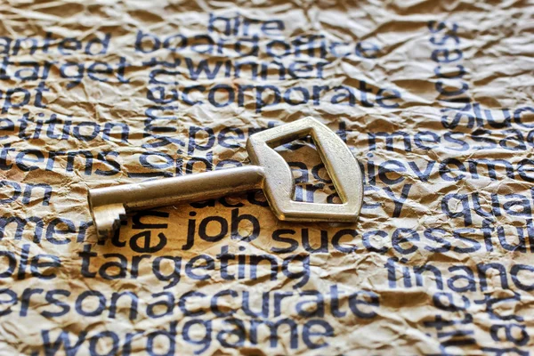 Golden key on job text — Stock Photo, Image