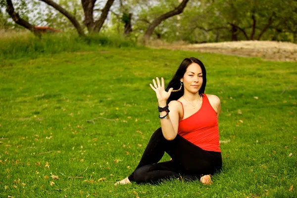 Woman Performs Sitting Sideways Twist in Park — Stock Photo, Image