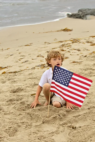 Boy Plants Flag in Beach Sand — Stock Photo, Image