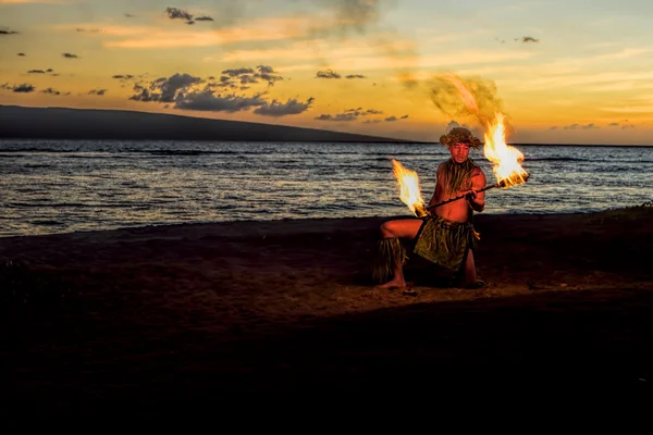 Fire Dancer at Dusk on Beach Stock Photo