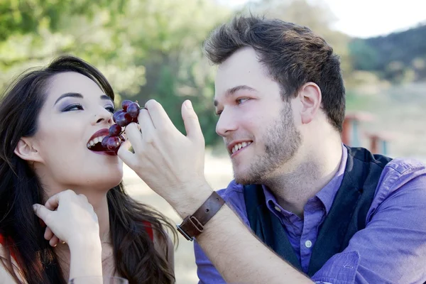 Man Feeds Woman Grapes Stock Image