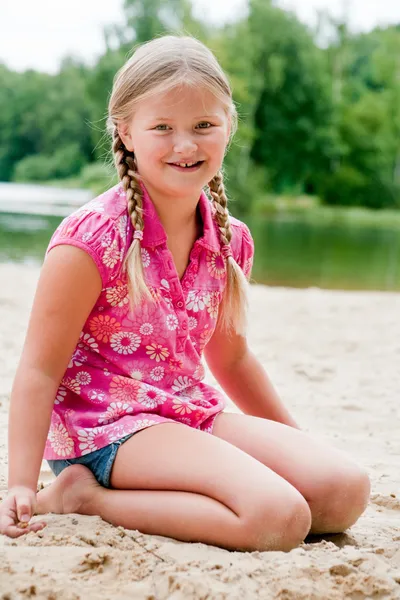 Sweet young child in the sand — Stock Photo, Image