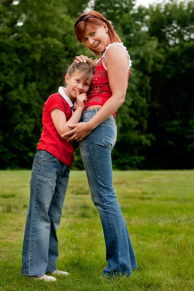 Happy mother and daugther in red — Stock Photo, Image