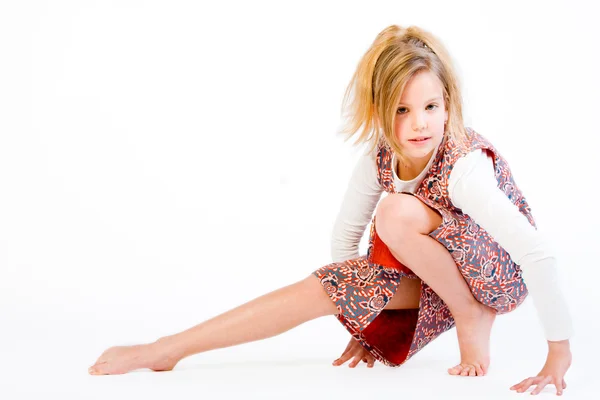 Blond child stretching her leg — Stock Photo, Image