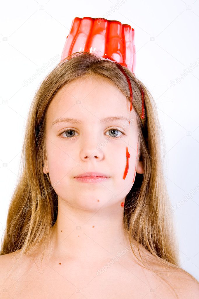 Blond child with desert on her head looking