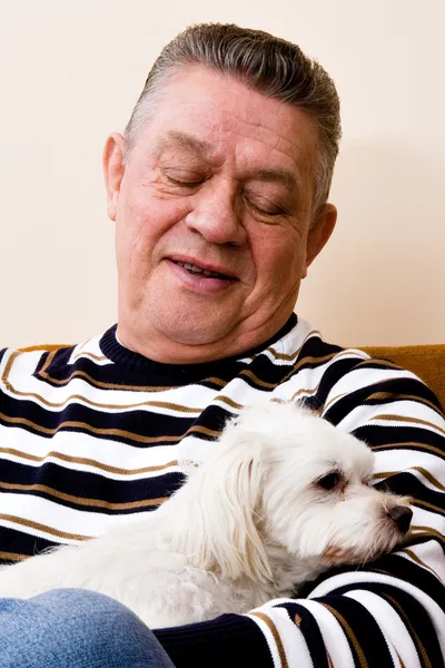 Grandfather giving his dog a loving look — Stock Photo, Image