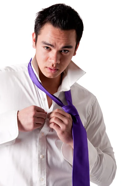Portrait of a strong young indonesian clothing himself — Stock Photo, Image