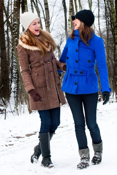 Sister laughing on a winter white road — Stock Photo, Image