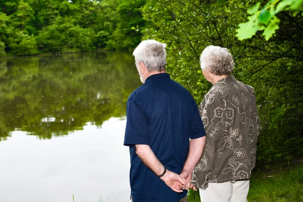 Grandparents watching the lake — Stock Photo, Image