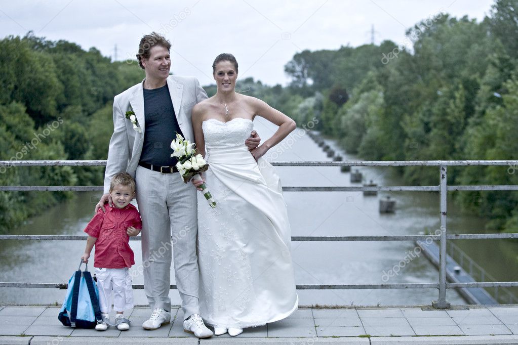 Wedding couple posing on a bridge