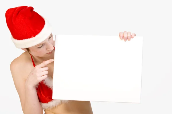Christmas girl holding up a white sign for copyspace — Stock Photo, Image
