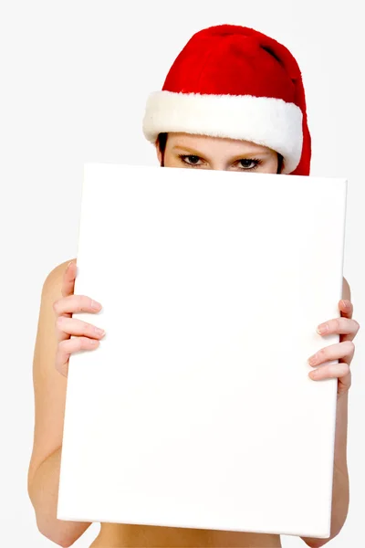 Christmas girl holding up a white sign for copyspace — Stock Photo, Image