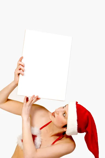 Christmas girl holding up a white sign for copyspace — Stock Photo, Image