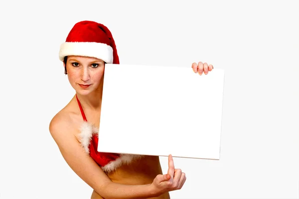 Christmas girl holding up a white sign for copyspace — Stock Photo, Image