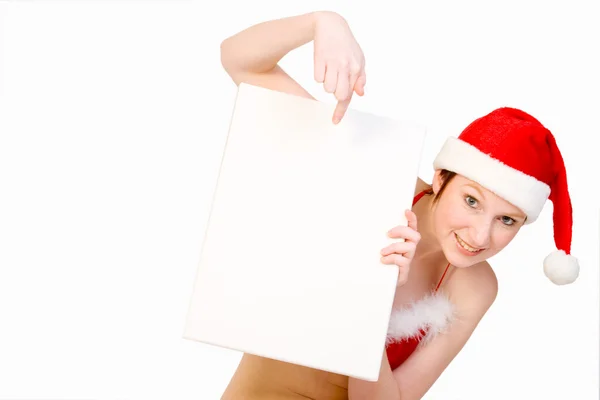 Christmas girl holding up a white sign for copyspace — Stock Photo, Image