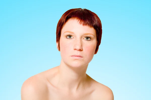 Studio portrait of a neutral looking young woman with short hair — Stock Photo, Image