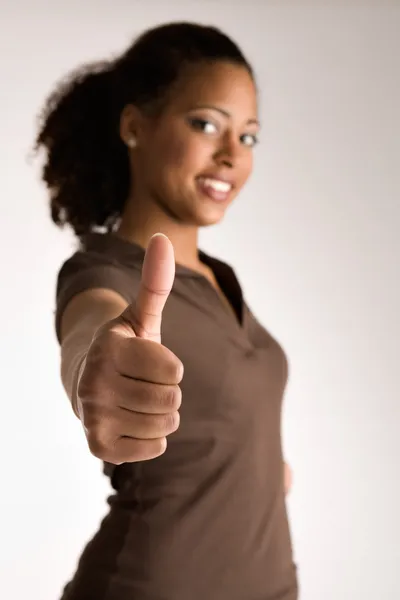 Woman is holding her thumb up — Stock Photo, Image