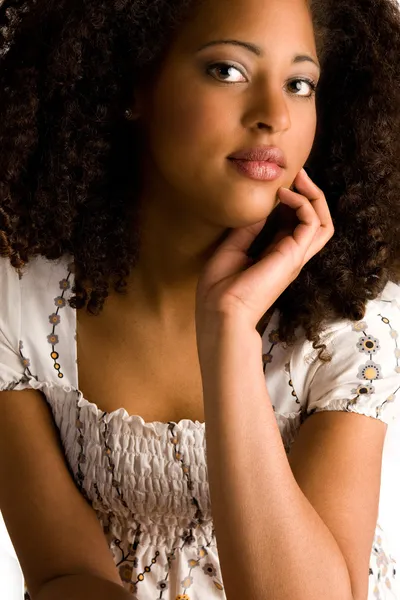 African woman with a hand on her chin — Stock Photo, Image