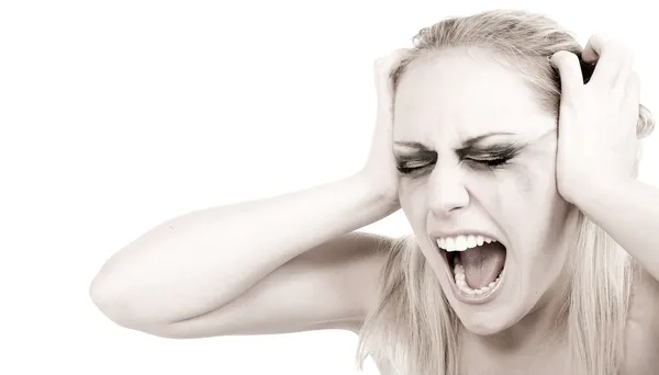 Studio portrait of a young blond woman in despair — Stock Photo, Image