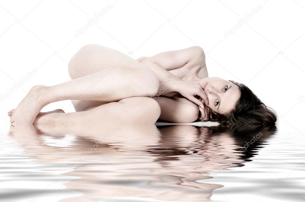 Sleeping naked model by the water