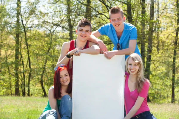 Teenagers presenting an empty copy space — Stock Photo, Image