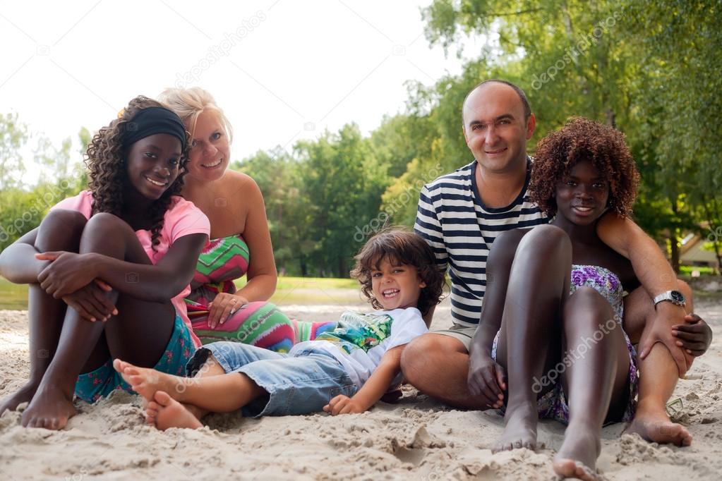Happy fosterfamily on the beach