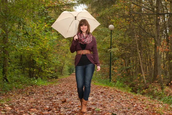 Walking with an umbrella — Stock Photo, Image