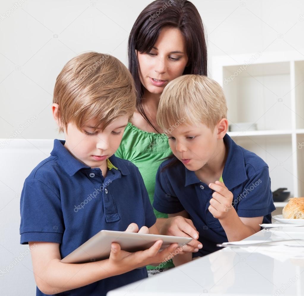 Two young boys using tablet computer
