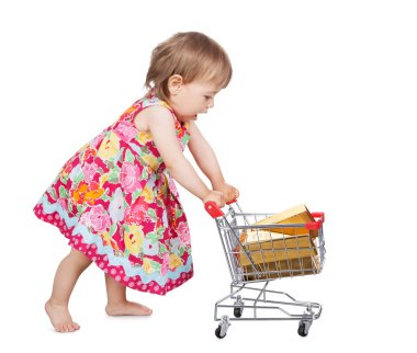 Little girl pushing a trolley