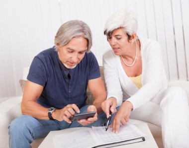 Senior couple doing their finances clipart