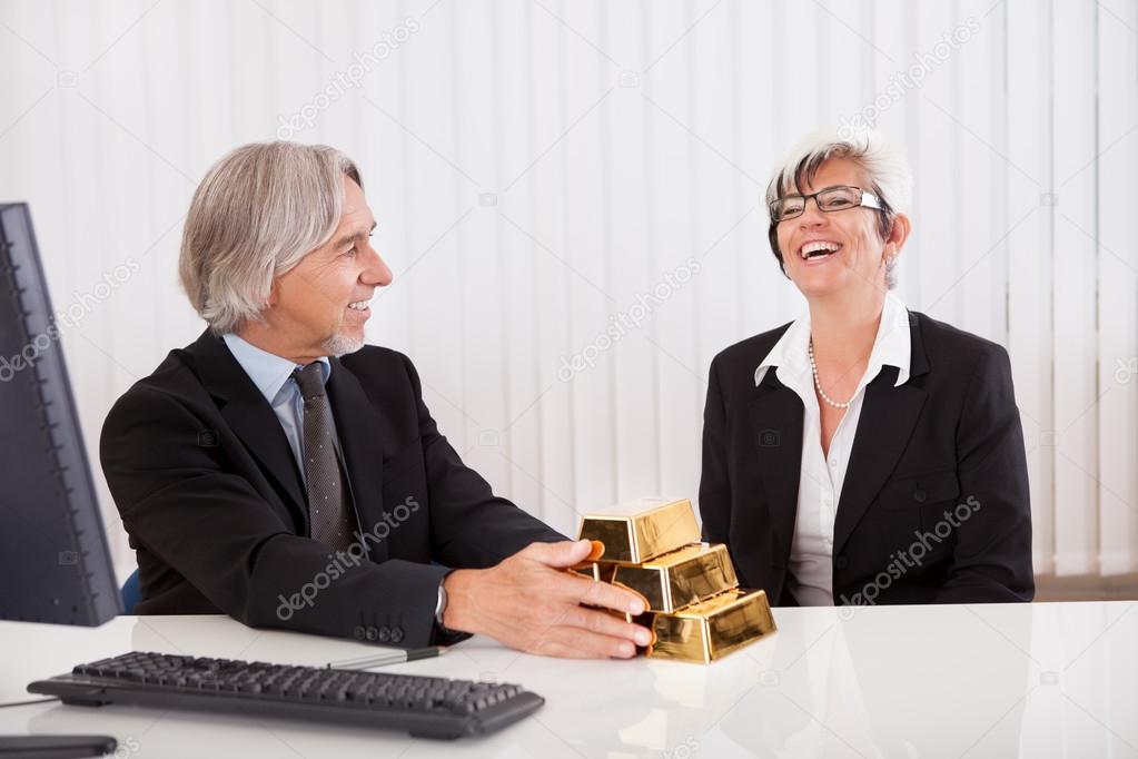 Businesswoman with gold bullion bars